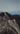 Girl standing tall on mountain 
